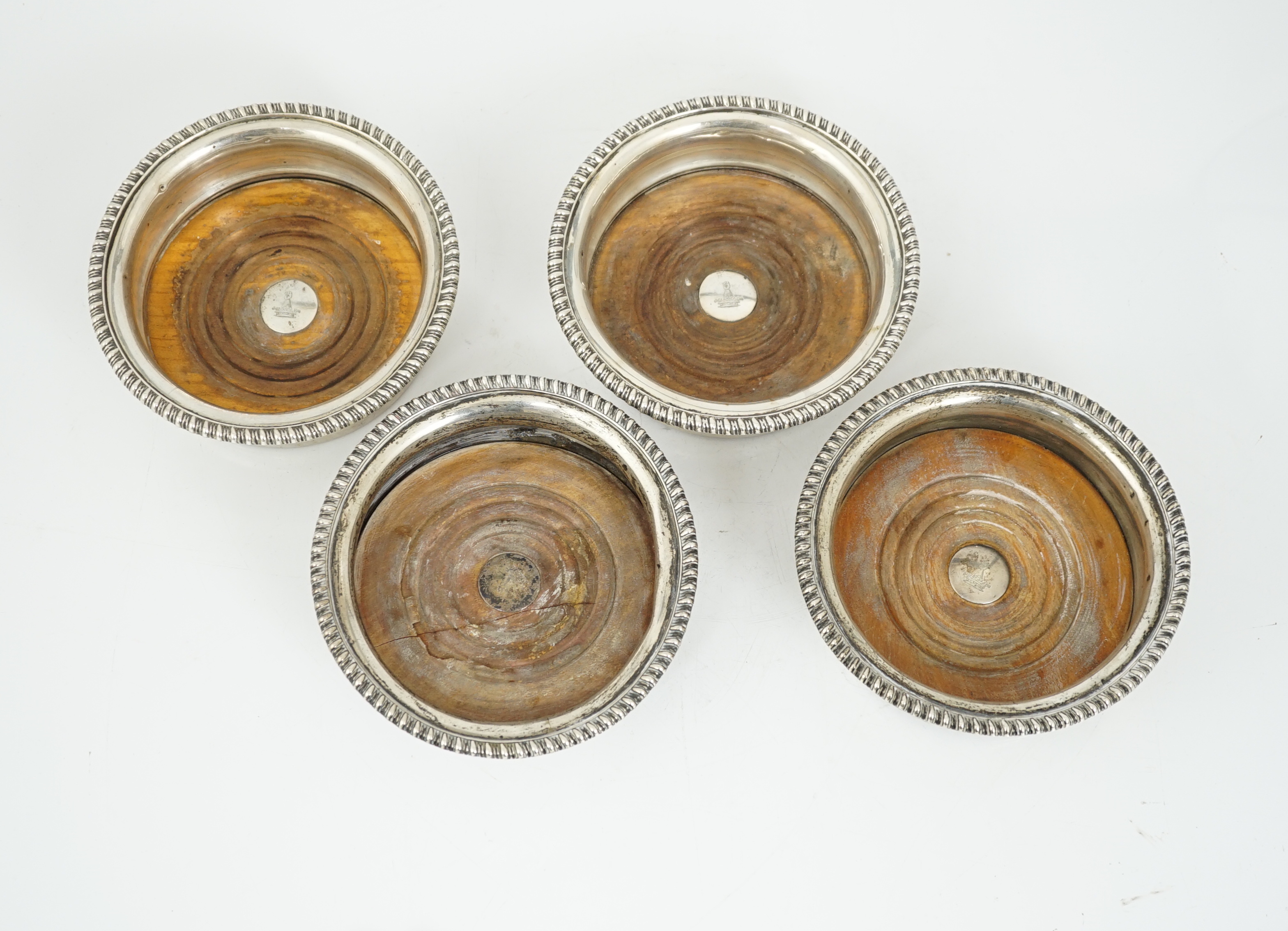 Two pairs of early 19th century silver mounted wine coasters